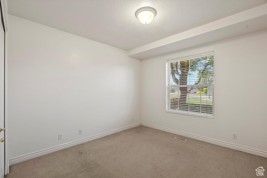Unfurnished room with carpet and baseboards