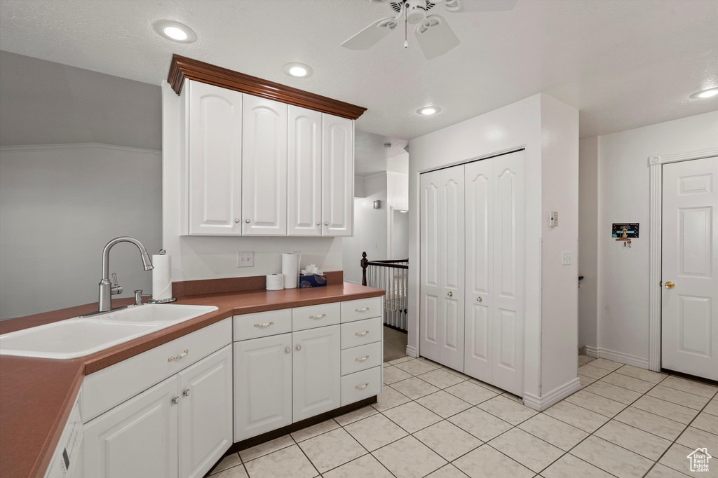 Kitchen featuring a ceiling fan, light tile patterned flooring, a sink, white cabinetry, and recessed lighting