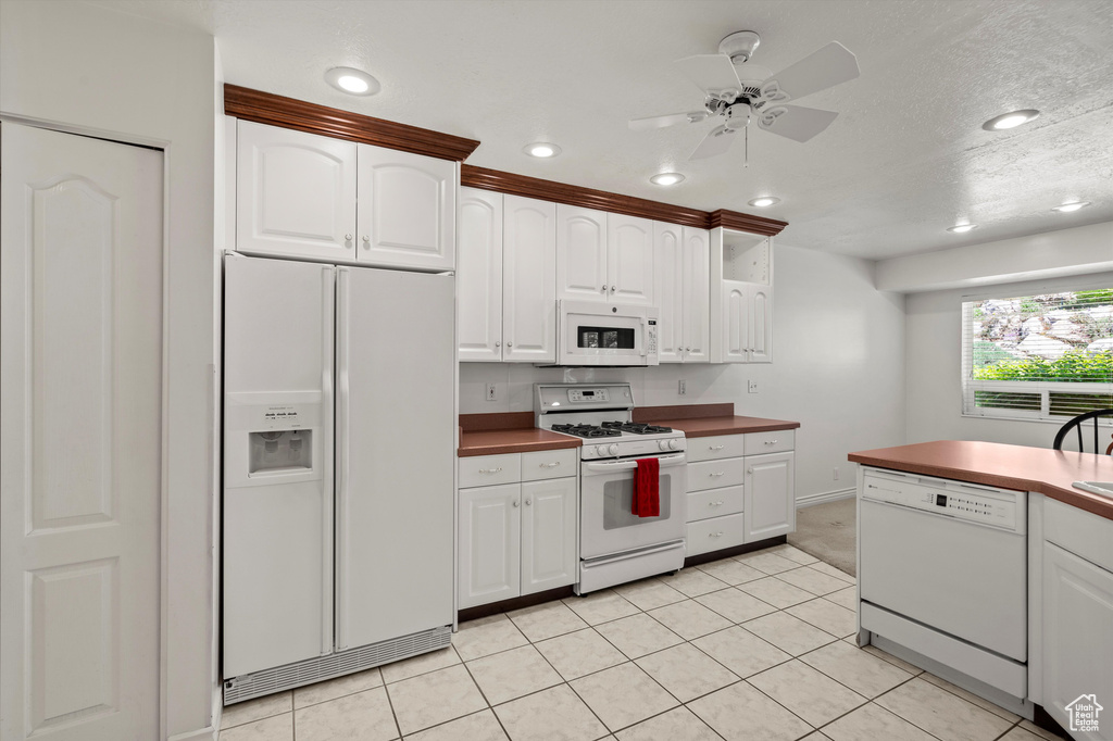 Kitchen featuring white appliances, ceiling fan, white cabinetry, recessed lighting, and light tile patterned flooring
