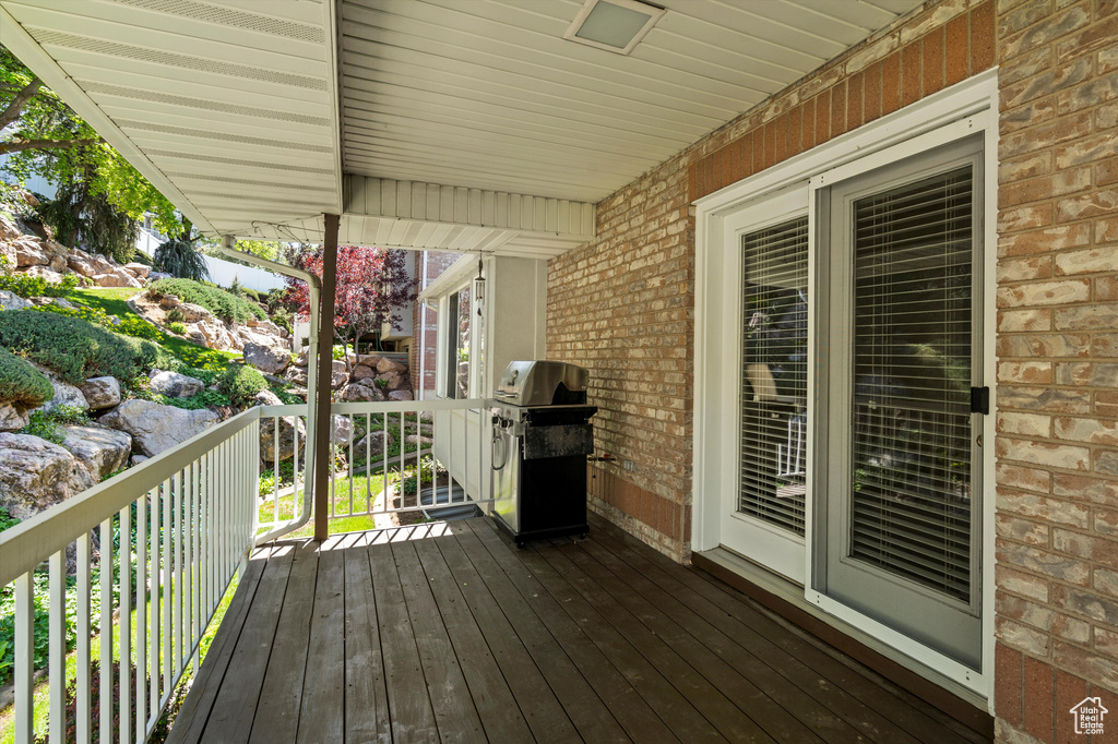 Wooden deck featuring a grill