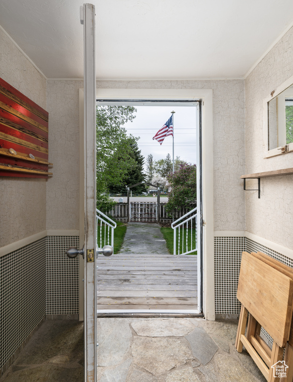Doorway with healthy amount of natural light and wainscoting