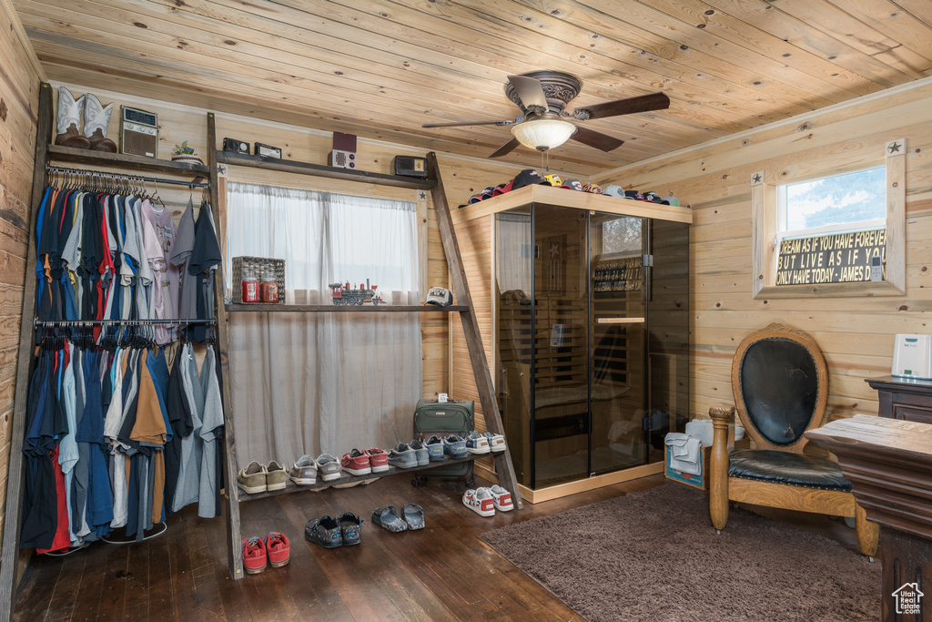 Bedroom featuring wooden ceiling, wooden walls, and hardwood / wood-style flooring