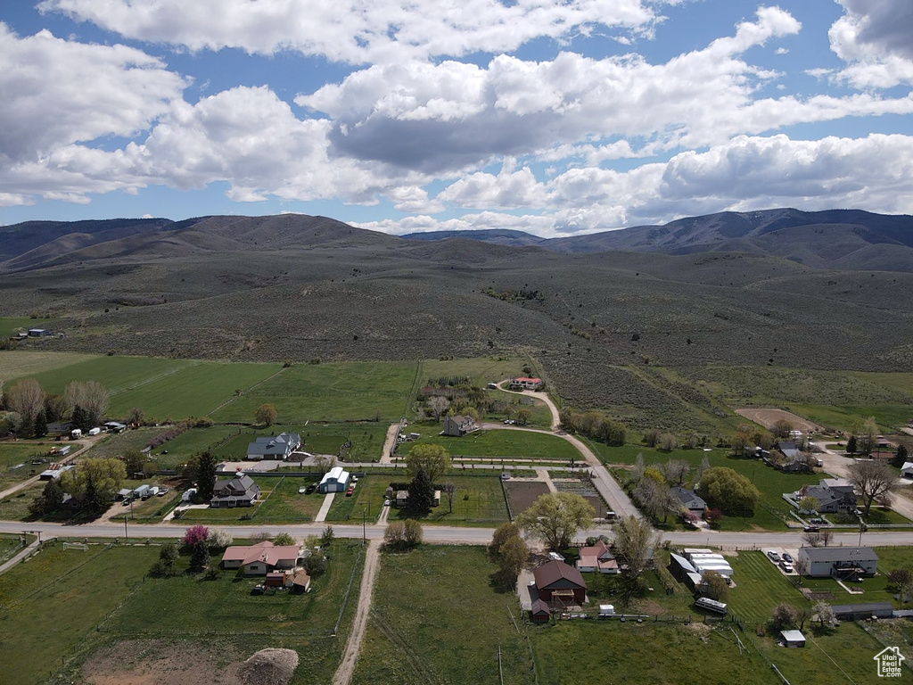 Aerial view of property's location with rural landscape and a mountain backdrop