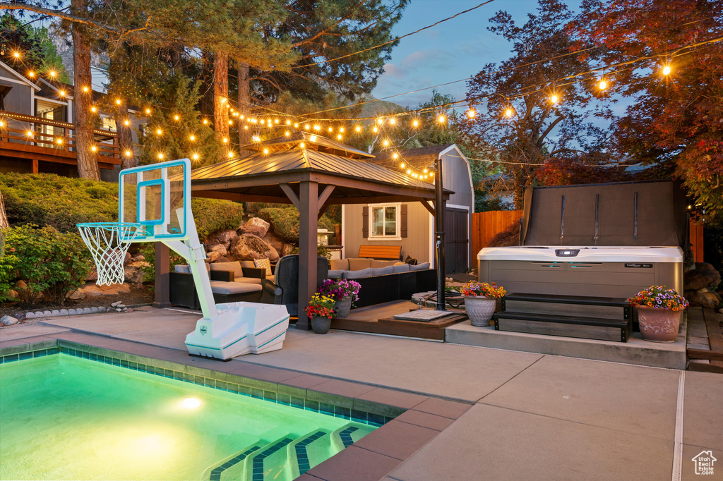 View of patio featuring a gazebo, an outdoor hangout area, an outdoor pool, and a hot tub