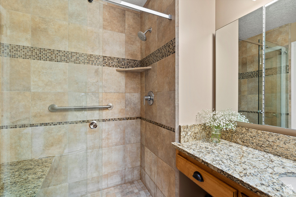 Full bathroom with a stall shower and vanity