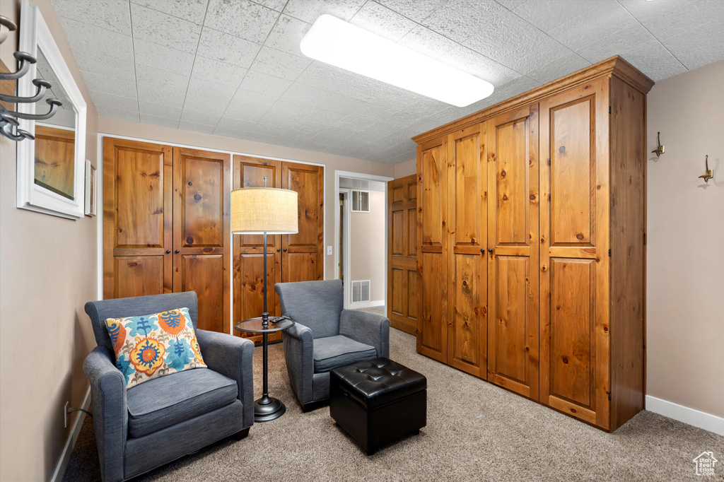 Living area with carpet and baseboards