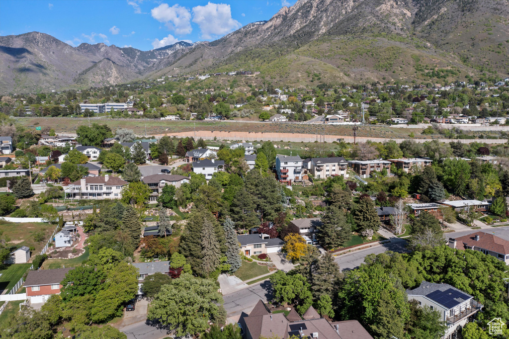 Aerial overview of property's location with a mountainous background and nearby suburban area