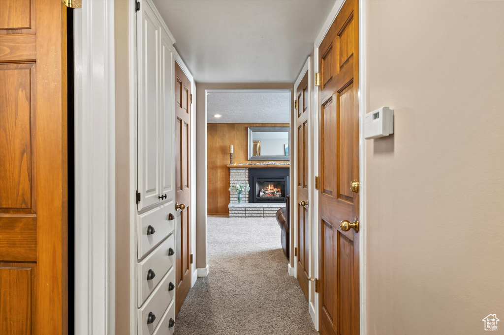 Corridor featuring carpet and baseboards