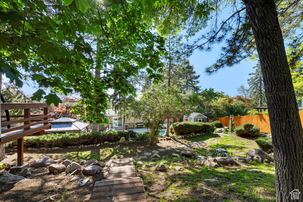 View of yard with fence and a wooden deck