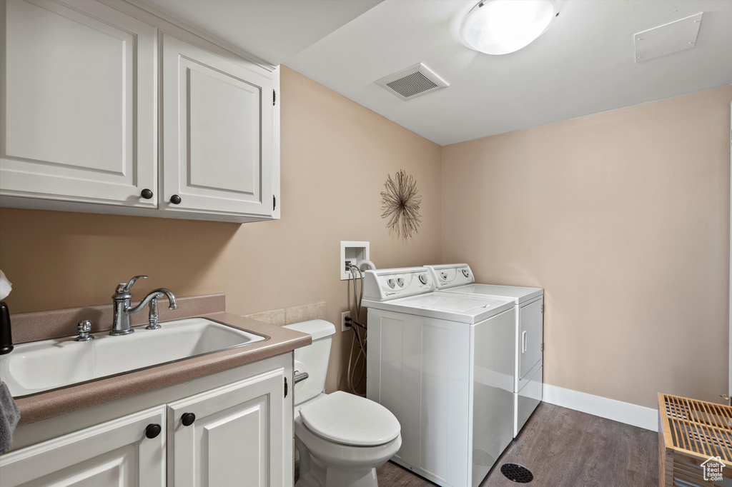 Laundry room featuring separate washer and dryer and dark wood-style floors