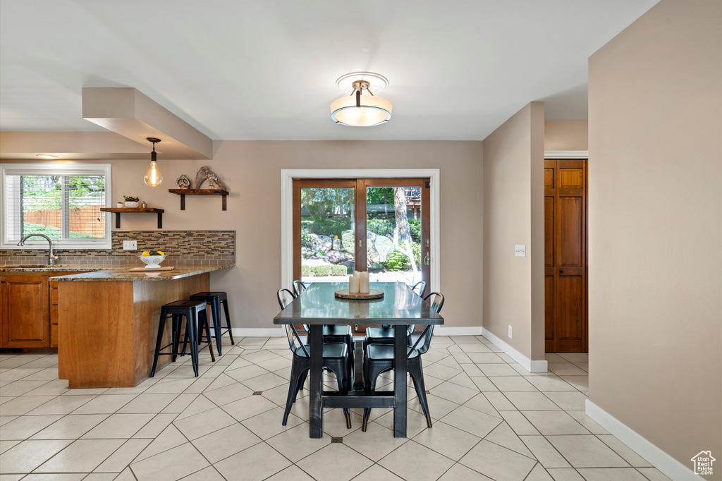 Dining area featuring baseboards and light tile patterned floors