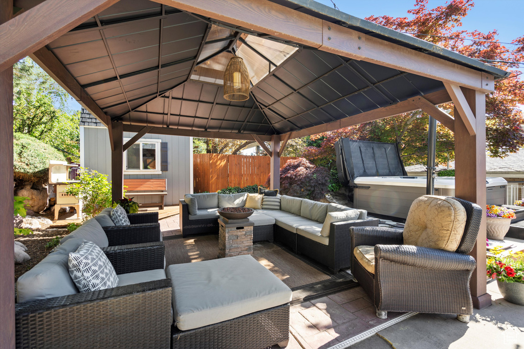 View of patio / terrace with a gazebo, an outdoor hangout area, and fence