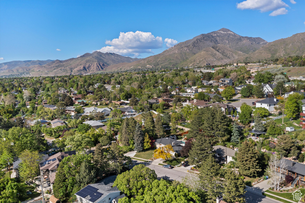 Aerial view of property's location featuring a mountainous background and nearby suburban area