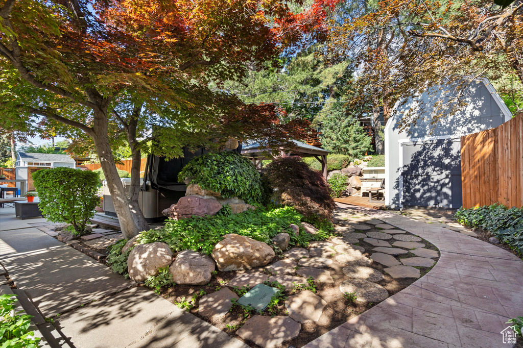 View of yard featuring a patio area, fence, and an outdoor structure
