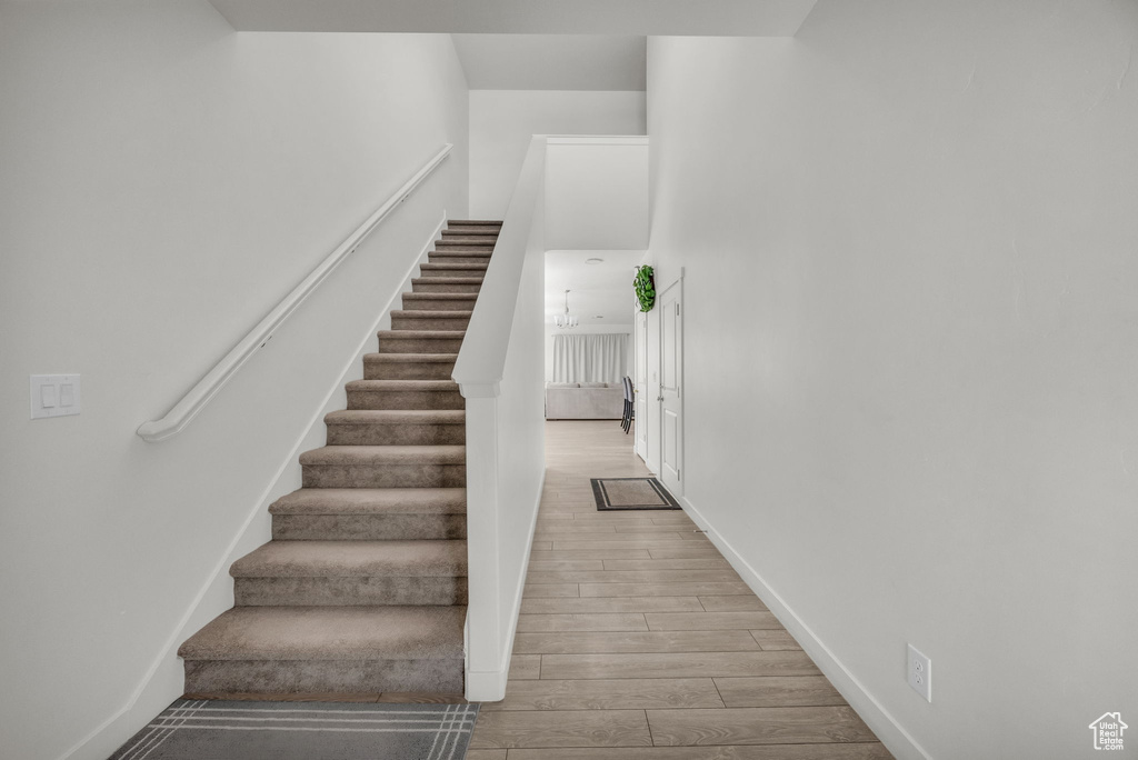 Stairway featuring wood finished floors and baseboards