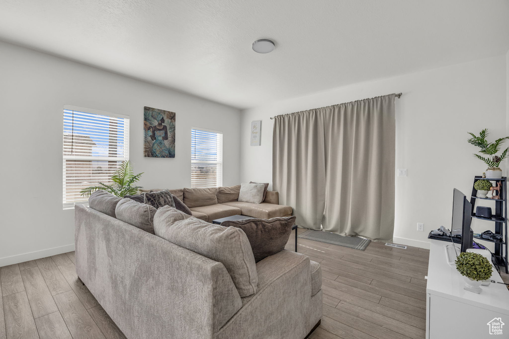 Living area with light wood-type flooring and baseboards