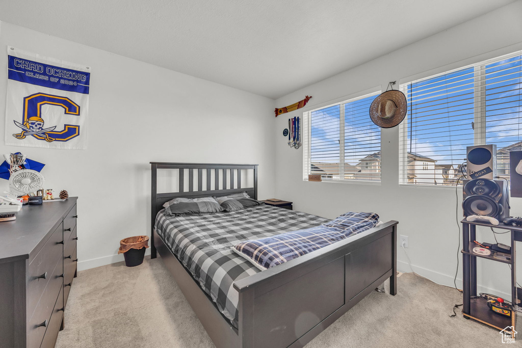 Carpeted bedroom featuring baseboards