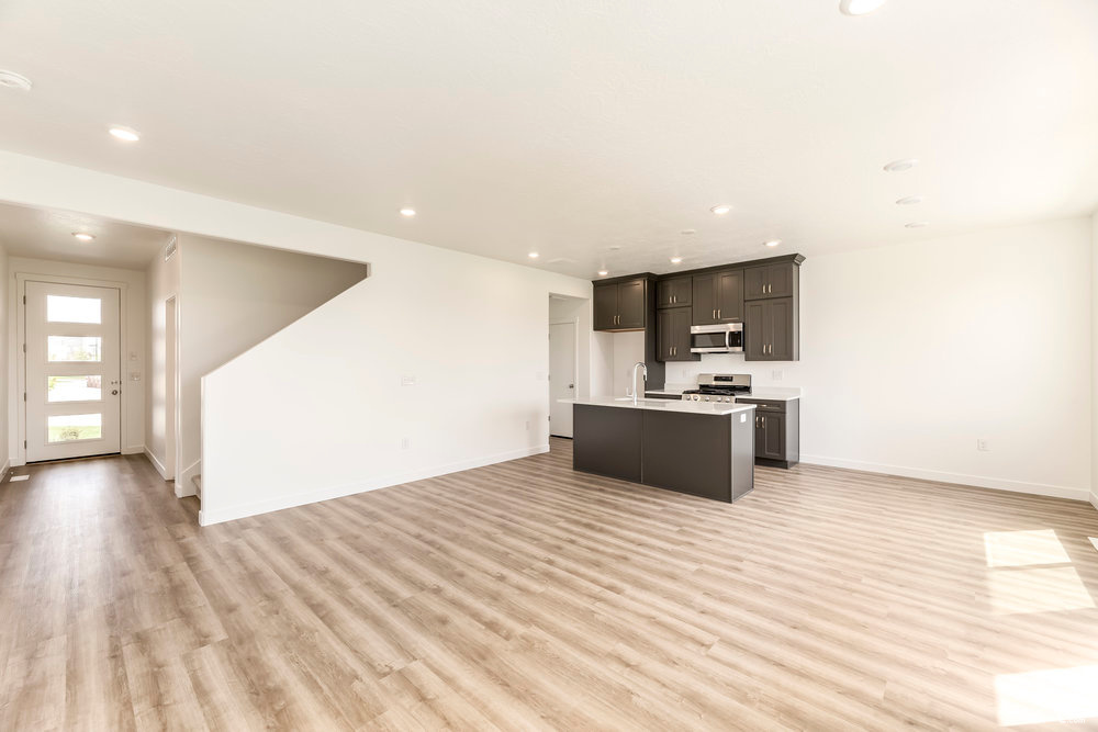 Kitchen featuring appliances with stainless steel finishes, open floor plan, baseboards, and recessed lighting