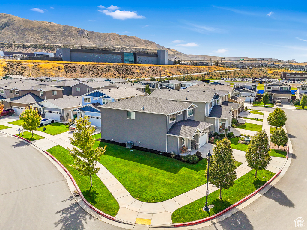 Aerial view of residential area featuring a mountainous background