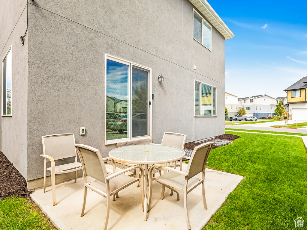 View of patio featuring outdoor dining space and a residential view