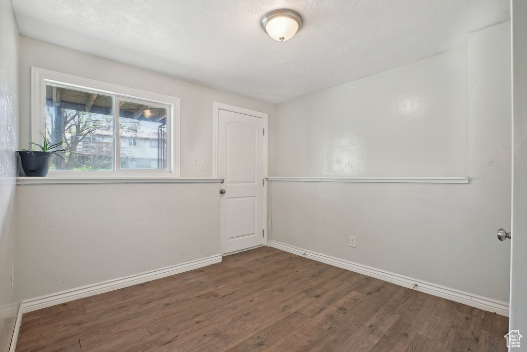 Spare room featuring wood finished floors and baseboards