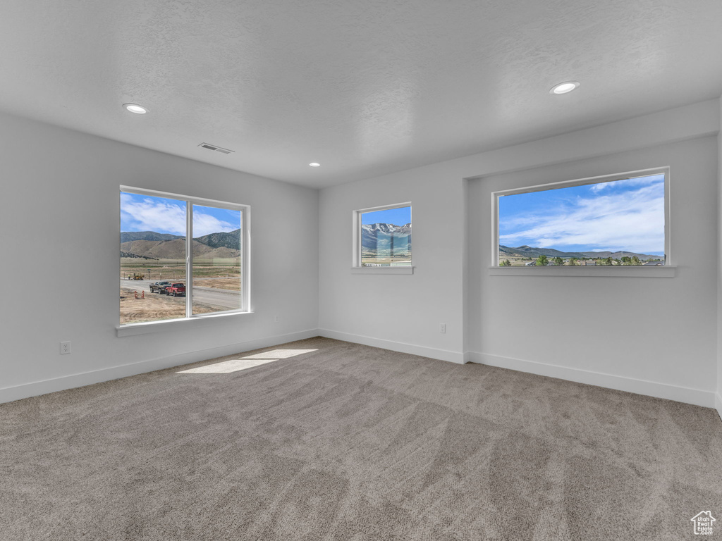 Unfurnished room featuring recessed lighting, baseboards, carpet, and a textured ceiling