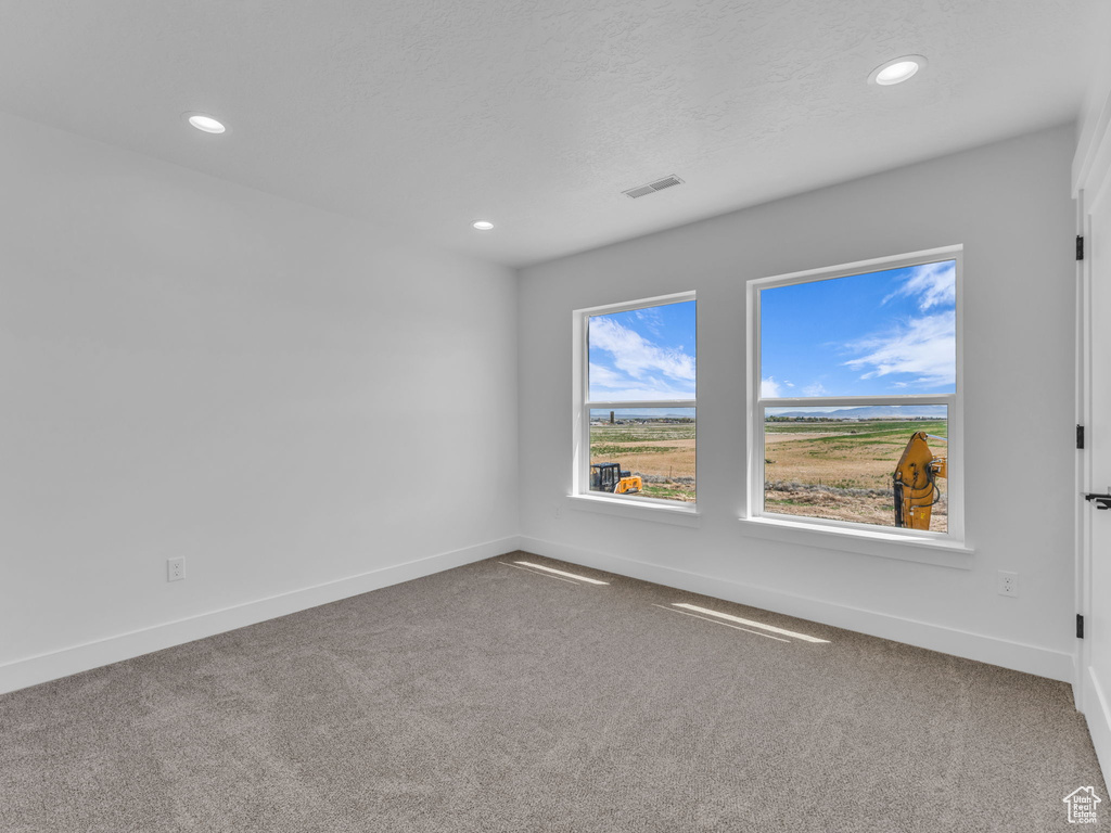 Unfurnished room with carpet floors, baseboards, and recessed lighting