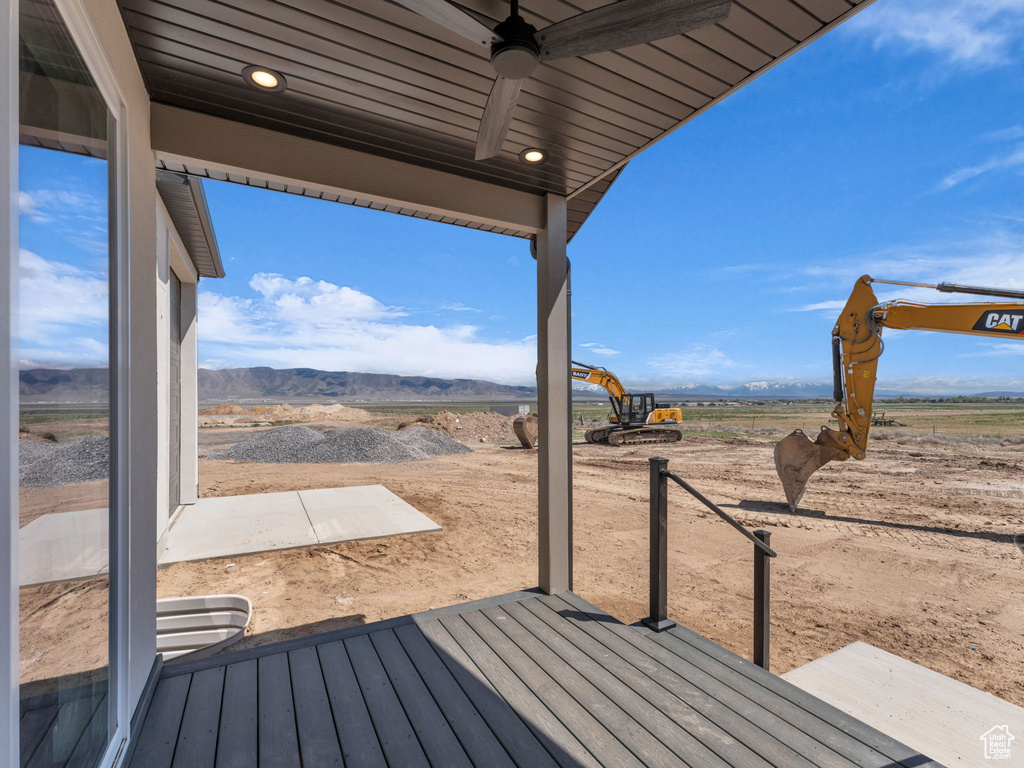 Wooden terrace with ceiling fan and a mountain view
