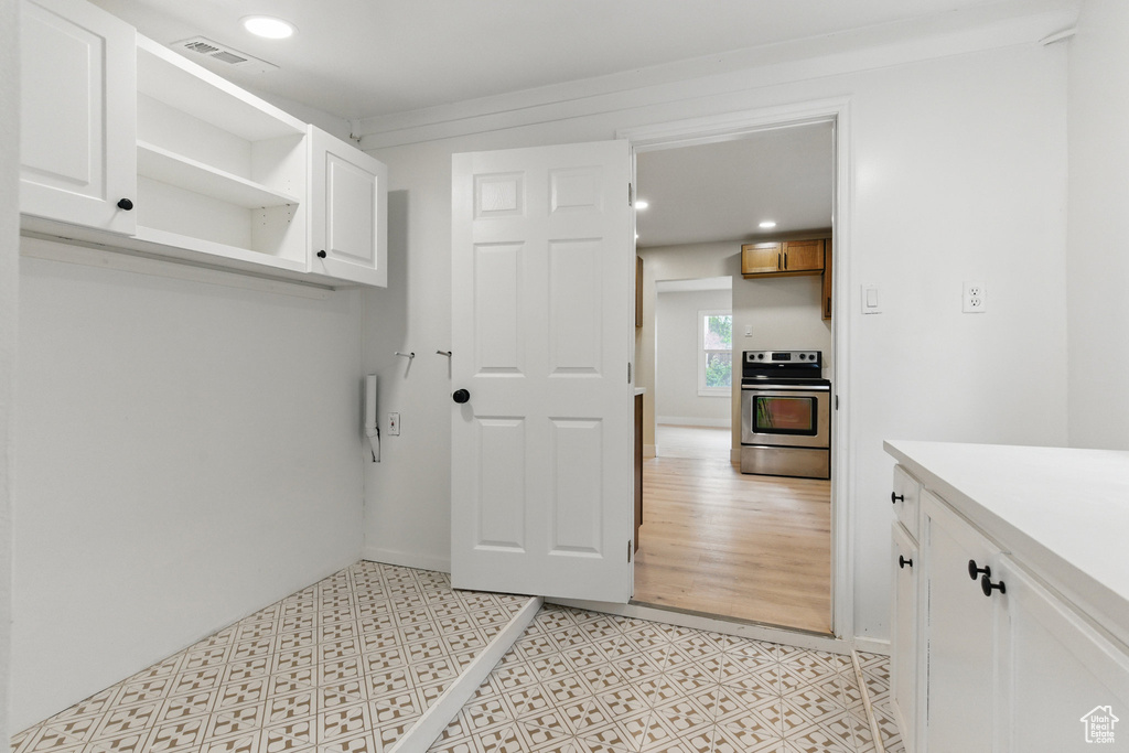 Mudroom featuring recessed lighting and light floors