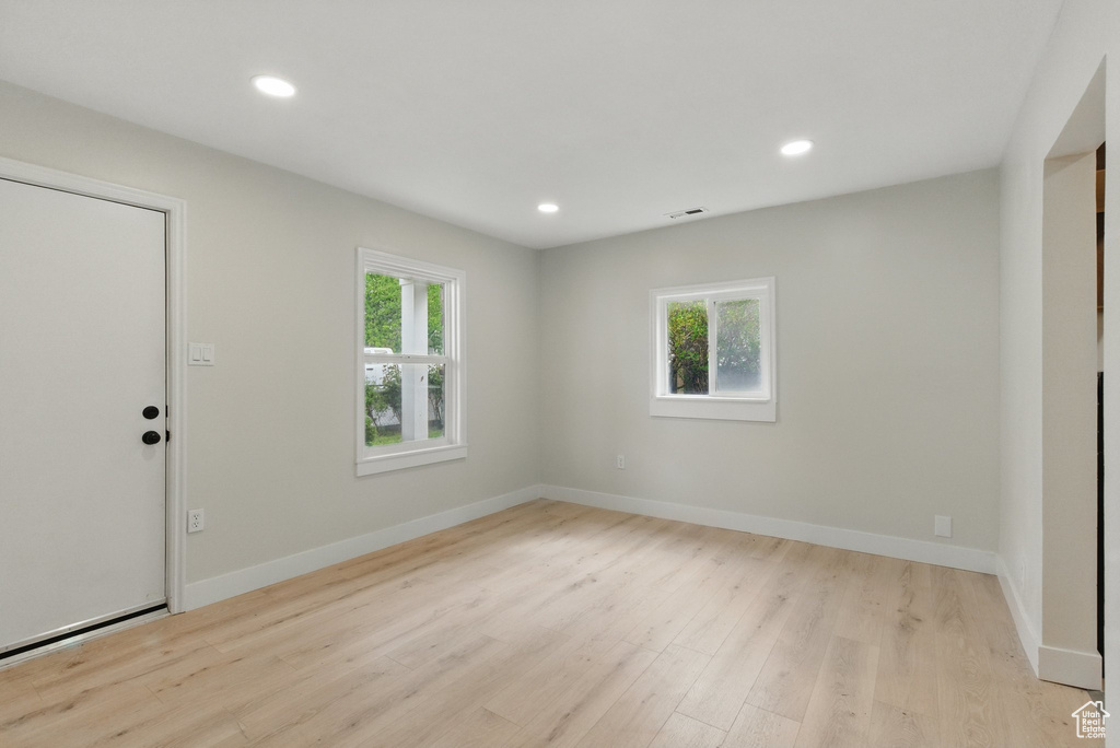 Foyer entrance with plenty of natural light, light wood-type flooring, recessed lighting, and baseboards