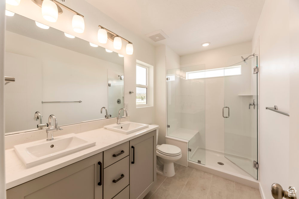 Bathroom with plenty of natural light, tile patterned flooring, a stall shower, and recessed lighting