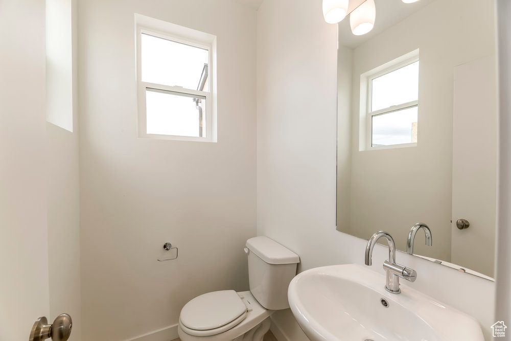 Half bathroom with a sink and toilet