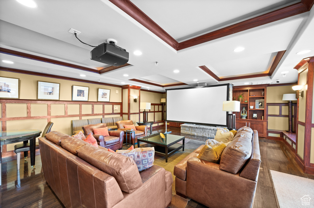 Cinema featuring a tray ceiling, crown molding, wainscoting, and recessed lighting