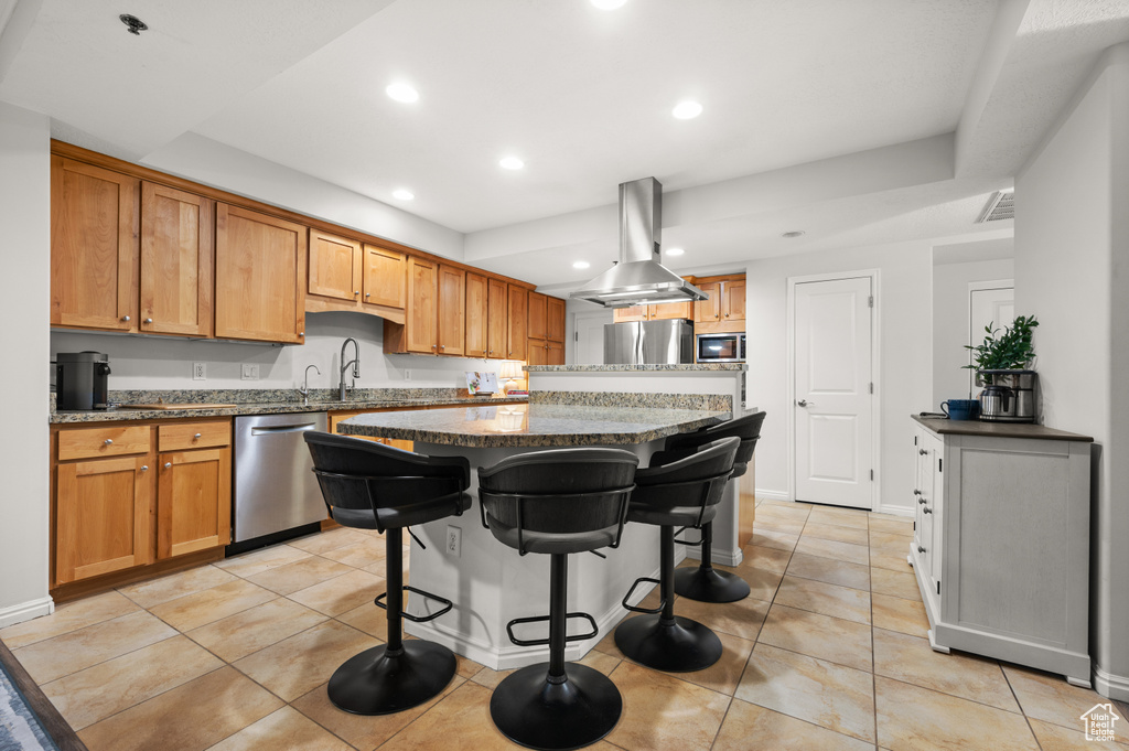 Kitchen featuring a center island, stainless steel appliances, visible vents, light tile patterned flooring, and recessed lighting