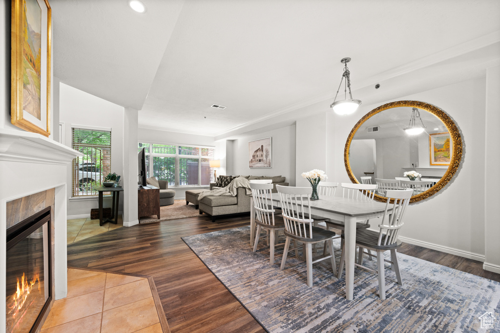 Dining area featuring recessed lighting, wood finished floors, baseboards, and a tile fireplace
