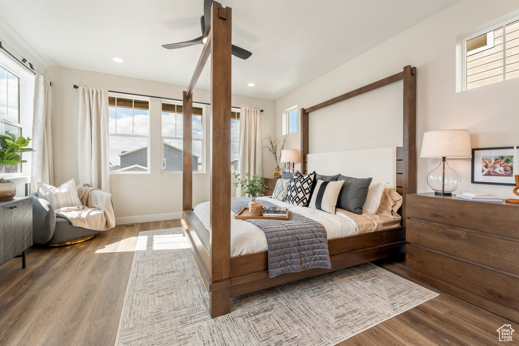 Bedroom with multiple windows, wood finished floors, recessed lighting, and a ceiling fan
