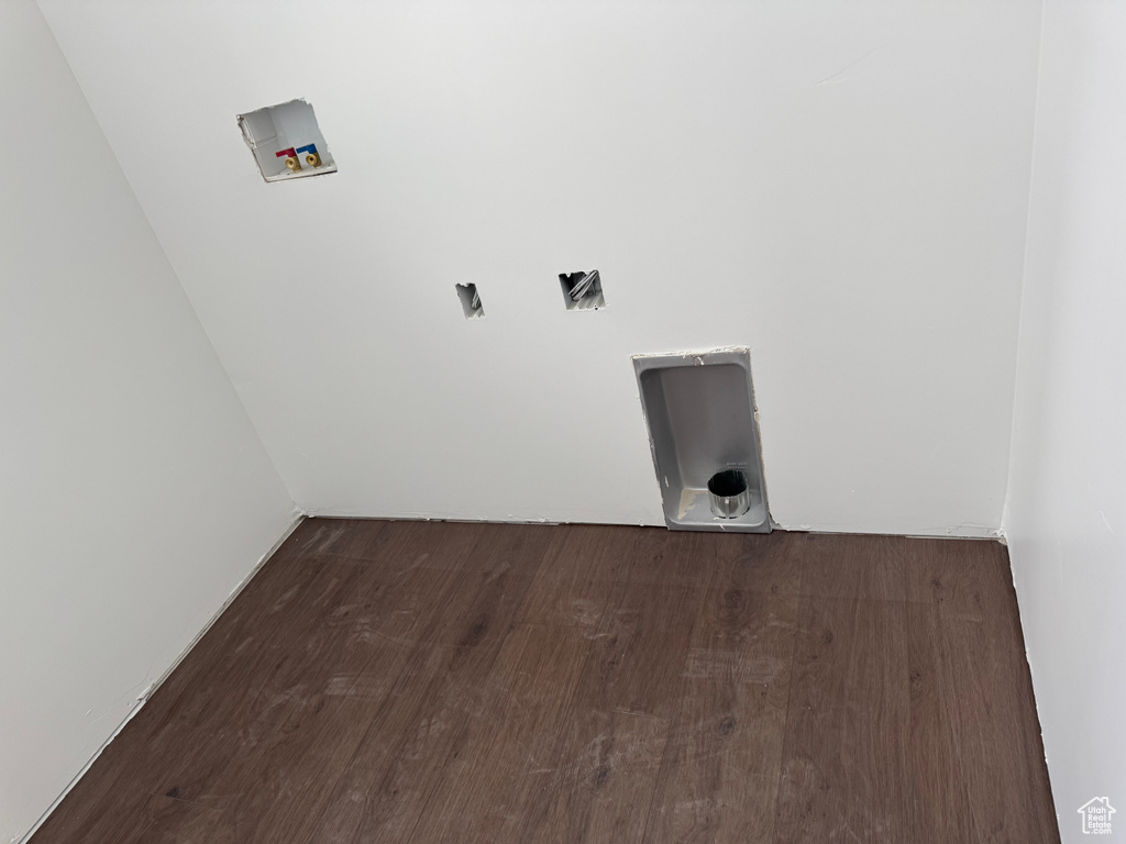 Laundry area featuring washer hookup and wood finished floors