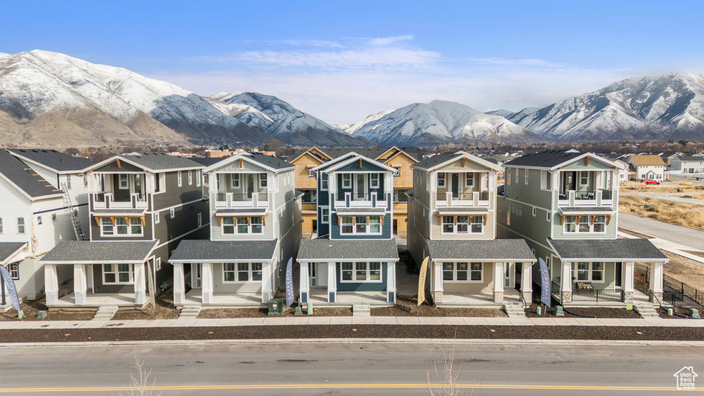 View of front of house with a porch, a residential view, and a mountain view