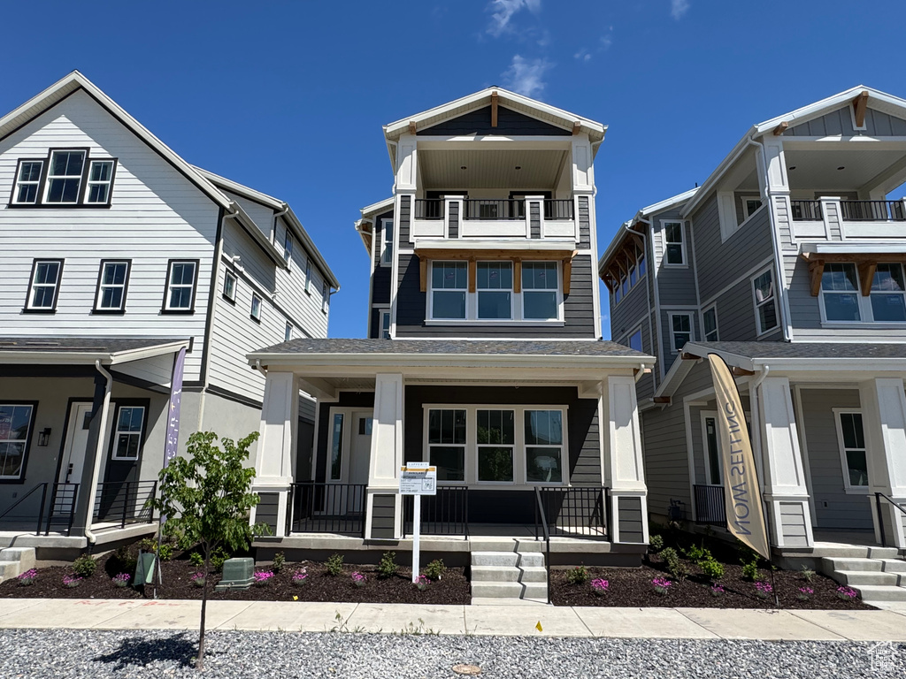 View of front facade featuring a porch and a balcony