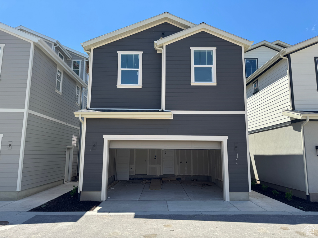 View of front of house featuring an attached garage and concrete driveway