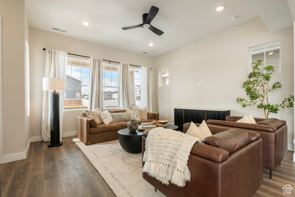 Living room with a ceiling fan, dark wood finished floors, recessed lighting, and baseboards
