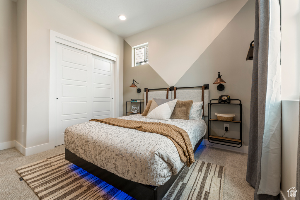 Bedroom with light carpet, a closet, baseboards, and recessed lighting