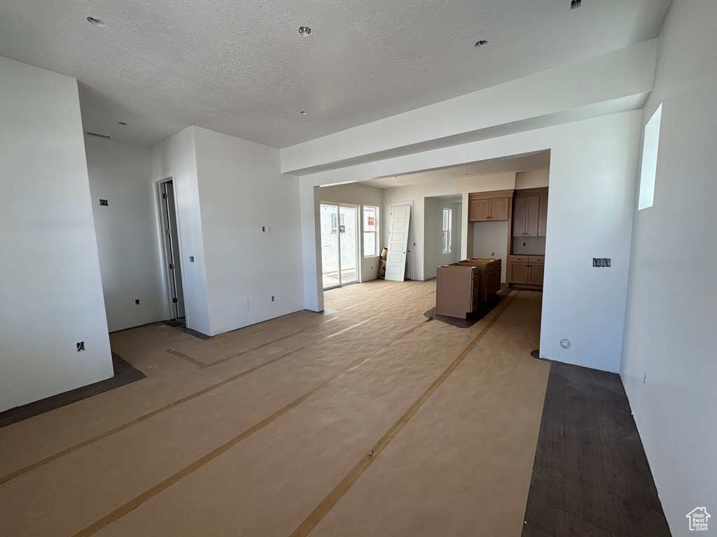 Unfurnished room with a textured ceiling