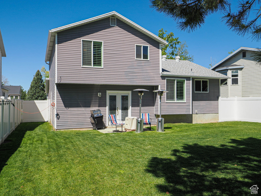 Back of property featuring french doors and a patio area