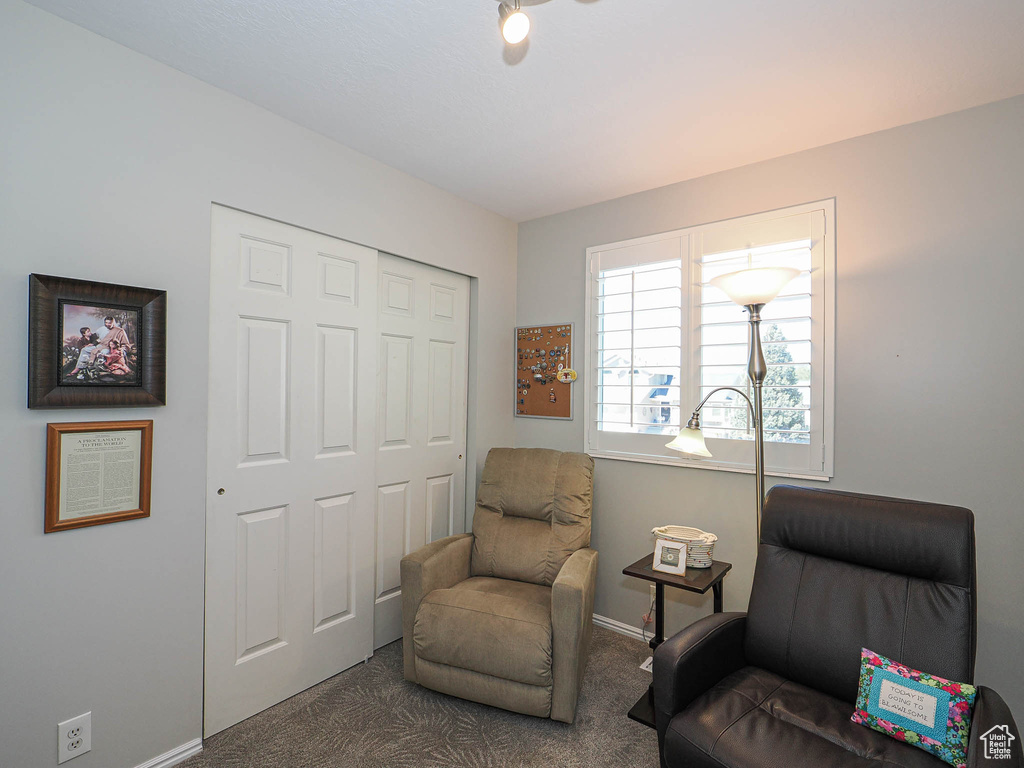 Living area with carpet and baseboards
