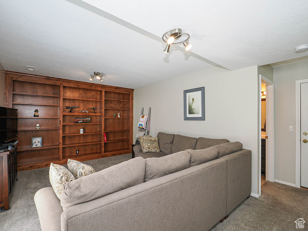 Carpeted living room with baseboards