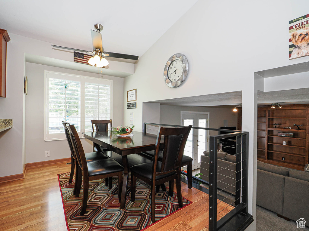 Dining room with light wood-type flooring, ceiling fan, and baseboards