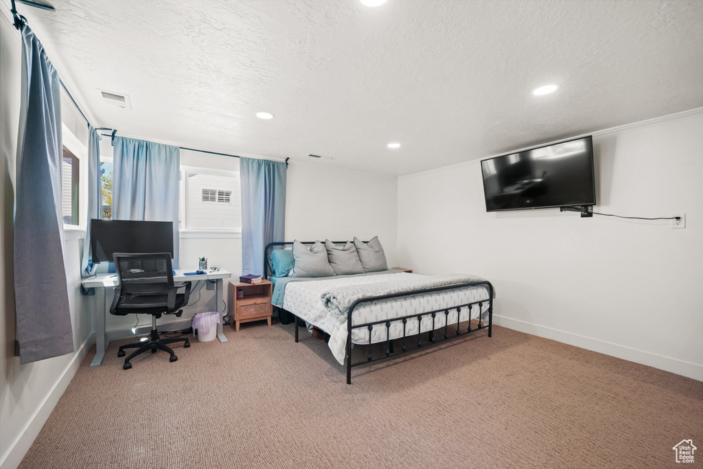 Bedroom featuring carpet, recessed lighting, baseboards, a textured ceiling, and an office area