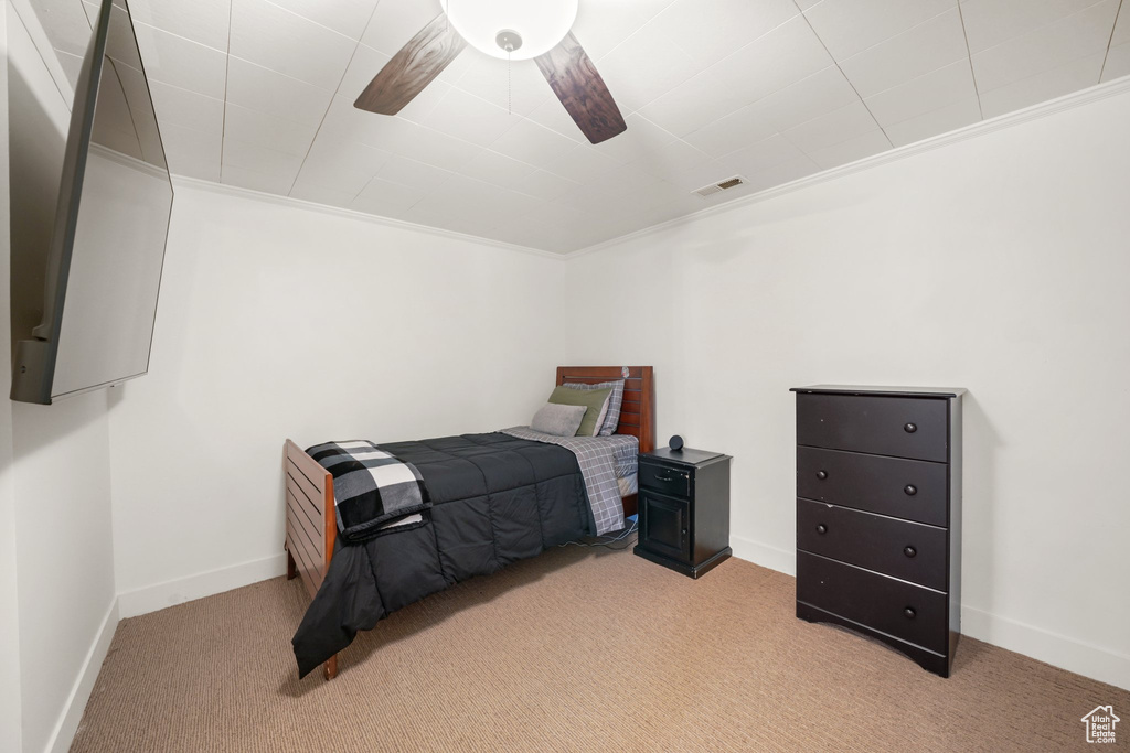 Bedroom featuring carpet, baseboards, and ornamental molding