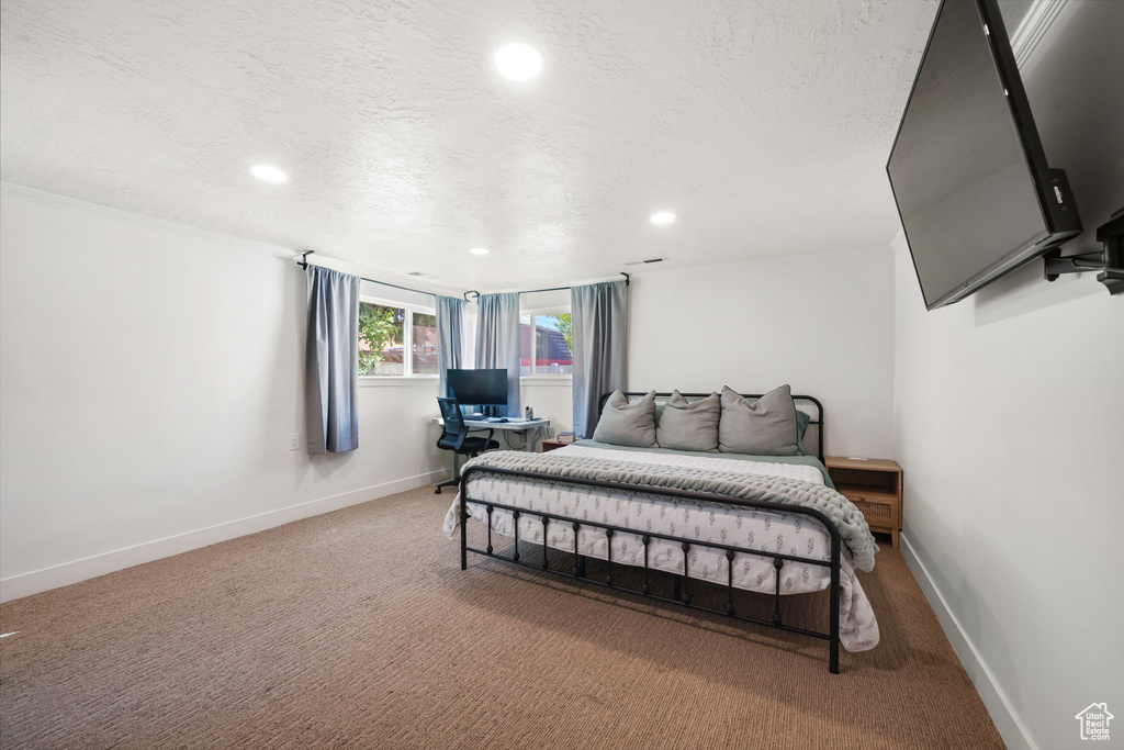 Carpeted bedroom with recessed lighting, a textured ceiling, and baseboards